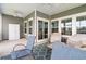 Spacious covered back porch featuring comfortable seating, ceiling fans, and sliding glass doors to the main house at 892 Harrison St., Myrtle Beach, SC 29579