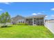 Picturesque backyard with a white picket fence, beautiful landscaping, and a screened-in porch for relaxing outdoors at 892 Harrison St., Myrtle Beach, SC 29579