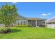 Well-manicured backyard with lush green grass, flowerbeds, and a screened-in porch, perfect for outdoor enjoyment at 892 Harrison St., Myrtle Beach, SC 29579
