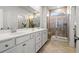 Bright bathroom featuring double sinks, lots of counter space, and a tiled walk-in shower at 892 Harrison St., Myrtle Beach, SC 29579