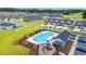 Aerial view of a community pool with lounge chairs, playground, and ample parking surrounded by well-maintained homes at 892 Harrison St., Myrtle Beach, SC 29579