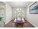 Cozy dining room with a wood table set for four, illuminated by a chandelier at 892 Harrison St., Myrtle Beach, SC 29579