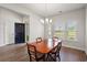 Bright dining area with wood floors, an elegant table and light fixture, and lots of natural light at 892 Harrison St., Myrtle Beach, SC 29579