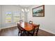 Traditional dining room featuring a wooden table, chandelier, and bright windows with a view at 892 Harrison St., Myrtle Beach, SC 29579