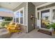 Inviting front porch with yellow rocking chairs and a charming welcome sign near the glass paneled front door at 892 Harrison St., Myrtle Beach, SC 29579