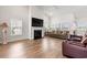 Bright living room featuring a cozy fireplace, hardwood floors, and large windows for natural light at 892 Harrison St., Myrtle Beach, SC 29579
