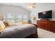 Light-filled primary bedroom with a ceiling fan, dresser with television, and lots of natural light at 892 Harrison St., Myrtle Beach, SC 29579