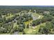 Aerial view of the community featuring a golf course, lake, and single Gathering homes at 90 Old Carriage Ln., Pawleys Island, SC 29585