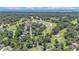 Breathtaking aerial view of a golf course community near the ocean featuring lush greenery and scenic water features at 90 Old Carriage Ln., Pawleys Island, SC 29585