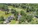 Stunning aerial view of a luxury home nestled on a lush golf course with beautiful landscaping and a lovely pond feature at 90 Old Carriage Ln., Pawleys Island, SC 29585