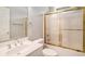 Bathroom featuring a tub with sliding glass doors and a vanity at 90 Old Carriage Ln., Pawleys Island, SC 29585