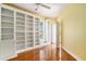 Spacious bedroom featuring hardwood floors, recessed lighting, and custom built-in bookshelves at 90 Old Carriage Ln., Pawleys Island, SC 29585