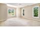 Bright, open bedroom with natural light and scenic views from the three windows at 90 Old Carriage Ln., Pawleys Island, SC 29585