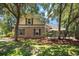 Classic brick home with lush landscaping and mature trees providing shade and privacy at 90 Old Carriage Ln., Pawleys Island, SC 29585