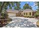 Attractive home featuring a brick facade, a two-car garage, and a well-manicured lawn at 90 Old Carriage Ln., Pawleys Island, SC 29585
