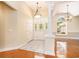 Bright foyer featuring tile flooring, a decorative front door, and an elegant chandelier at 90 Old Carriage Ln., Pawleys Island, SC 29585
