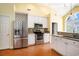 Bright kitchen with stainless steel refrigerator and stove, granite counters, and convenient breakfast bar at 90 Old Carriage Ln., Pawleys Island, SC 29585