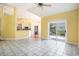 Bright, open-concept living room with tile floors, fan, and sliding glass doors to the outdoor patio at 90 Old Carriage Ln., Pawleys Island, SC 29585