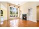 Bright living room with a fireplace, built-in shelving, and large windows offering a scenic view at 90 Old Carriage Ln., Pawleys Island, SC 29585