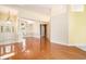 Open-concept living area with hardwood floors, a decorative front door, and elegant light fixtures at 90 Old Carriage Ln., Pawleys Island, SC 29585