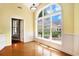 Cozy living room with large arched window overlooking the landscaped backyard, providing natural light at 90 Old Carriage Ln., Pawleys Island, SC 29585