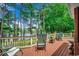 Inviting back deck with rocking chairs overlooking a serene lake and lush greenery at 911 Tilghman Forest Dr., North Myrtle Beach, SC 29582