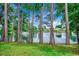 Backyard with a serene lake, fountain, and lush greenery, perfect for relaxation at 911 Tilghman Forest Dr., North Myrtle Beach, SC 29582