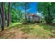 Backyard with lush greenery and mature trees; a tranquil setting for relaxing and enjoying the beauty of nature at 911 Tilghman Forest Dr., North Myrtle Beach, SC 29582