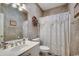 Well-lit bathroom with a vanity, framed pictures, and a toilet with a decorative shower curtain at 911 Tilghman Forest Dr., North Myrtle Beach, SC 29582