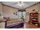 Comfortable bedroom with a patterned quilt, vintage bookshelf, and natural light from the windows at 911 Tilghman Forest Dr., North Myrtle Beach, SC 29582