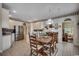 Eat-in kitchen and dining area with tile floors, stainless refrigerator, and view of the living room at 911 Tilghman Forest Dr., North Myrtle Beach, SC 29582