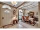 This formal dining room features an arched window, decorative molding, and a dining table for six at 911 Tilghman Forest Dr., North Myrtle Beach, SC 29582