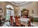 Bright dining room with a chandelier, large window and a dining table set for a dinner party at 911 Tilghman Forest Dr., North Myrtle Beach, SC 29582
