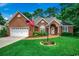 Charming brick home with an arched entry, brick walkway, beautiful lawn and two car garage at 911 Tilghman Forest Dr., North Myrtle Beach, SC 29582