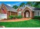 Beautiful brick home featuring a brick walkway, arched entry, and attractive landscaping at 911 Tilghman Forest Dr., North Myrtle Beach, SC 29582
