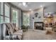 Cozy living room with fireplace, tile flooring and lots of natural light through the white shuttered windows at 911 Tilghman Forest Dr., North Myrtle Beach, SC 29582