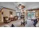 Spacious living room with a cozy fireplace, ceiling fan, plush seating and neutral decor at 911 Tilghman Forest Dr., North Myrtle Beach, SC 29582