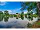 Wide angle pond view reflecting blue sky and neighborhood houses at 911 Tilghman Forest Dr., North Myrtle Beach, SC 29582