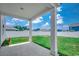 Back porch overlooking a spacious, fenced backyard under a bright, cloudy sky at 960 Corn Husk Loop, Conway, SC 29527