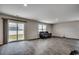 Bright living room with sliding glass doors, neutral walls, and wood-look flooring at 960 Corn Husk Loop, Conway, SC 29527