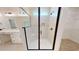 Beautiful bathroom featuring a walk-in shower with white tiling and dark hardware at 974 Crooked Oak Dr., Pawleys Island, SC 29585