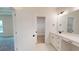 Bathroom area with white vanity, drawers, sink, with a view to the walk-in closet at 974 Crooked Oak Dr., Pawleys Island, SC 29585
