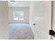 Bedroom with neutral carpeting, window, and a view of the yard at 974 Crooked Oak Dr., Pawleys Island, SC 29585