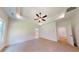 Spacious bedroom with neutral colored carpet, ceiling fan, and tray ceiling at 974 Crooked Oak Dr., Pawleys Island, SC 29585