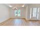 Bright entryway featuring wood-look flooring, shiplap accent wall, and an elegant chandelier at 974 Crooked Oak Dr., Pawleys Island, SC 29585
