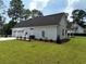 Side view showcasing the home's garage and well-manicured lawn at 974 Crooked Oak Dr., Pawleys Island, SC 29585