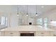 Open-concept kitchen with large island overlooking the living area and fireplace at 974 Crooked Oak Dr., Pawleys Island, SC 29585