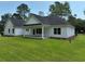 Backyard view showcasing the home's spacious lot and covered patio at 974 Crooked Oak Dr., Pawleys Island, SC 29585
