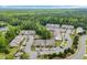 Aerial view of a well-planned community, showcasing the attractive townhomes, lush greenery, and ample parking spaces at 1001 Dinger Ct. # 1001, Myrtle Beach, SC 29588