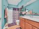 Functional bathroom featuring tiled floors, a shower-tub combo, and practical storage solutions at 1001 Dinger Ct. # 1001, Myrtle Beach, SC 29588